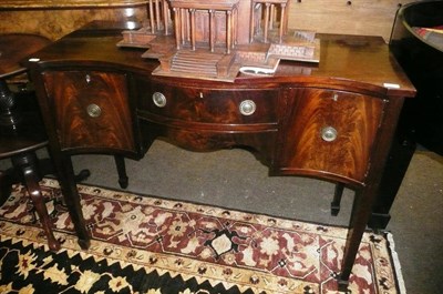 Lot 759 - A mahogany reproduction serpentine sideboard