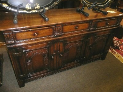 Lot 769 - Titchmarch and Goodwin suite consisting of a draw leaf table, a set of six carved oak dining chairs