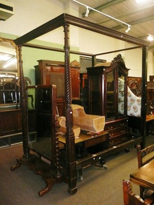 Lot 778 - Mahogany four poster bed with turned spiral fluted columns, pair of mounting blocks and button back