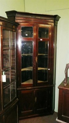 Lot 796 - A mahogany standing glazed corner cabinet