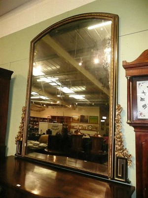 Lot 818 - A large Victorian gilt and ebonised over mantel mirror with carved gilt wood foliate motifs