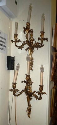 Lot 828 - Pair of carved three branch wall lights