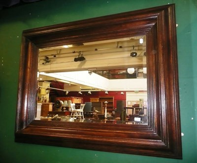 Lot 1108 - A large oak framed wall mirror