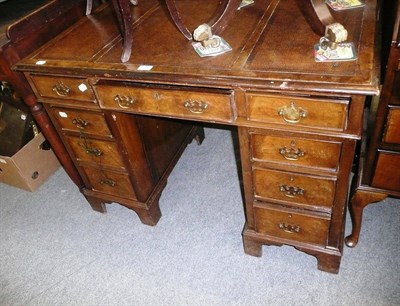 Lot 1122 - A walnut pedestal desk with brown leather top