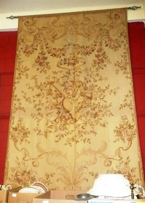 Lot 1243 - A large wool work wall hanging the cream field with rococo scrolls and floral vines centred by...