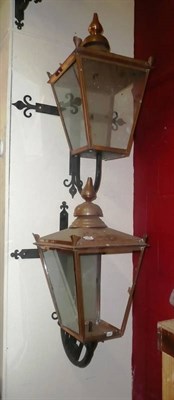 Lot 1258 - A pair of large copper framed lanterns on wrought iron brackets