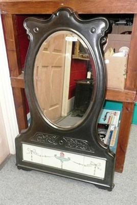 Lot 1276 - A black painted cast iron wall mirror with a tile insert