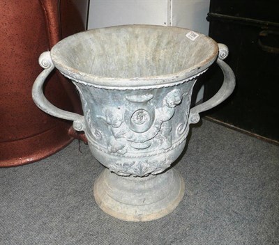 Lot 1306 - A pair of lead garden pedestal urns with relief decoration