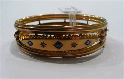 Lot 9 - A 9ct gold sapphire and diamond bangle