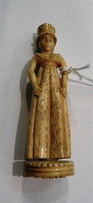 Lot 24 - A whalebone figurative pipe tamper, mid 19th century, as a young woman wearing a tall hat and dress
