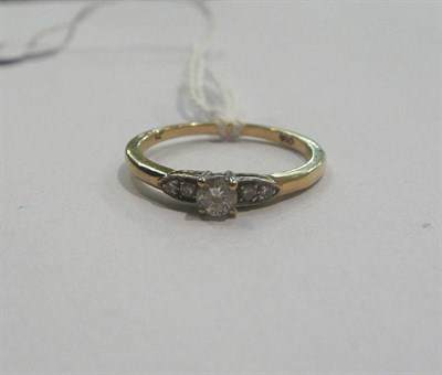 Lot 34 - A diamond solitaire ring with diamond-set shoulders