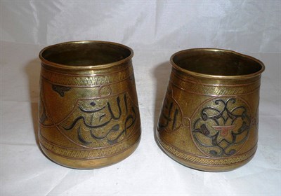 Lot 96 - Pair of Cairo ware Islamic silver inlaid vases ('God is Almighty' inscriptions)