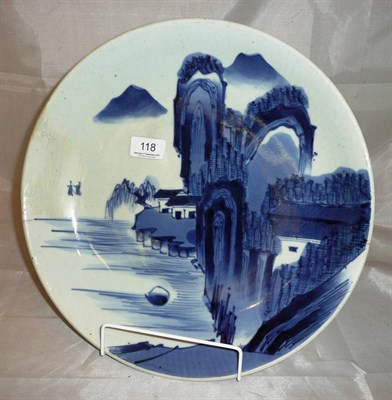 Lot 118 - A Chinese blue and white dish decorated with a mountainous landscape