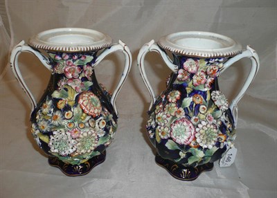 Lot 146 - A pair of flower encrusted vases