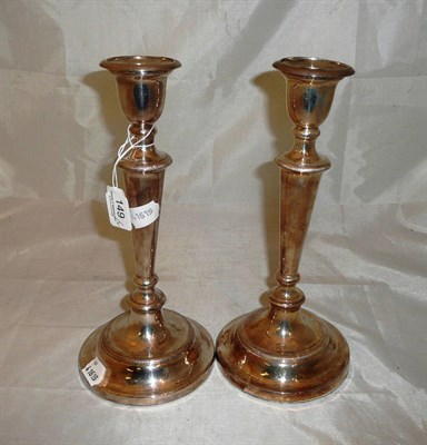 Lot 149 - A pair of silver candlesticks with loaded bases