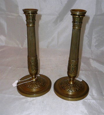 Lot 173 - Pair of French 'Empire' brass candlesticks with associated sconces
