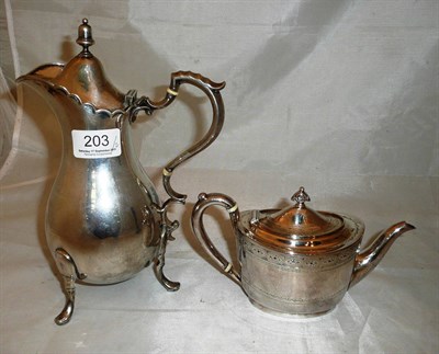 Lot 203 - A white metal hot water jug stamped 800, engraved with a coat of arms, and a white metal tea pot