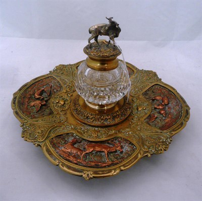 Lot 276 - A brass and copper repoussé inkstand dish