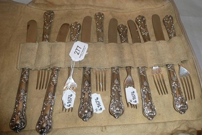 Lot 277 - A set of six silver handled knives and forks with repoussé decoration of vines