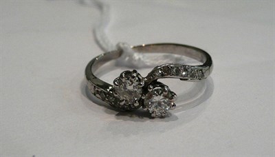 Lot 286 - A diamond two stone twist ring with stone set shoulders