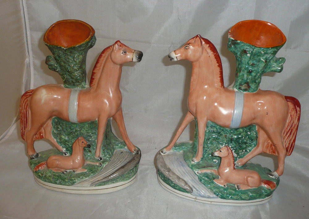 Lot 451 - A pair of Staffordshire horse spill vases