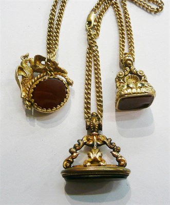 Lot 11 - Two gilt seal fobs, a swivel fob and a chain