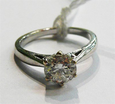 Lot 18 - A diamond solitaire ring, the round brilliant cut diamond in a white six claw setting, to a tapered