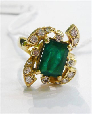 Lot 20 - An emerald and diamond cluster ring, a step cut emerald within a scrolling frame set with diamonds