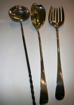 Lot 49 - A George IV table spoon (adapted), a Hester Bateman serving spoon (adapted as a fork), a Baleen...