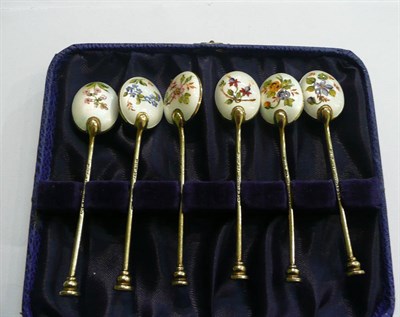 Lot 54 - Set of six florally enamelled seal end silver gilt coffee spoons, cased  #