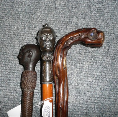 Lot 72 - Gold plated and hardstone 'root' walking stick; a beagling whip with cast iron 'Slave' bust...