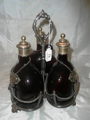 Lot 74 - Amber tinted three bottle glass decanter stand