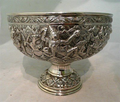 Lot 128 - A Burmese white metal bowl, circa 1890, the pedestal foot supporting a circular bowl chased...