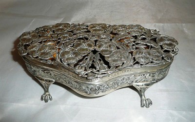 Lot 143 - An Edwardian silver serpentine trinket box, by William Comyns, with pierced poppy design lid,...