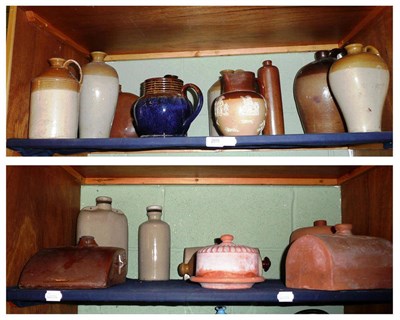 Lot 269 - Two shelves of stoneware bottles, hot water bottles and terracotta pieces *