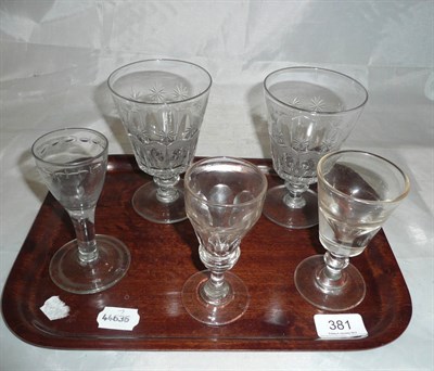 Lot 381 - A pair of engraved glass rummers, two wine glasses on short stems and another with swelled knop