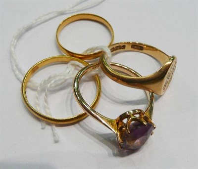 Lot 405 - A 22ct gold wedding band, a band ring, an amethyst ring and a 9ct gold signet ring