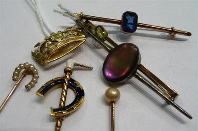 Lot 419 - A naval crown brooch, an enamelled horseshoe and crop stick pin, a seed pearl horseshoe stick...