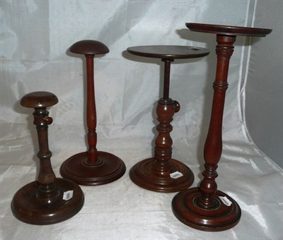 Lot 437 - Four mahogany wig stands *