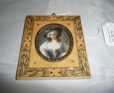 Lot 414A - A miniature portrait of a lady wearing full dress and a hat with flowers