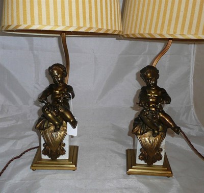 Lot 12 - Two gilt cherub lamps