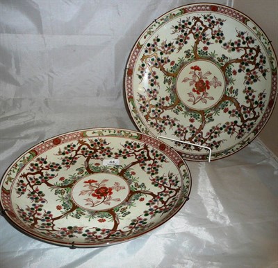 Lot 44 - A pair of Japanese chargers with painted and gilt decoration of trees