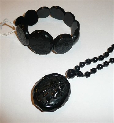 Lot 95 - A carved jet bracelet and a jet cameo pendant (a.f.) on a French jet necklace