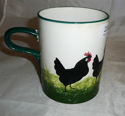 Lot 233 - A Robert Heron "Wemyss Ware" mug, painted with a black cockerel and three chickens on a sponged...