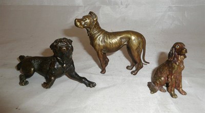 Lot 245 - Three bronze and cold painted dog figures, largest 7cm high