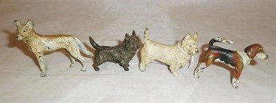 Lot 260 - Four small bronze/cold painted figures of dogs, the largest 6cm high, all previously mounted