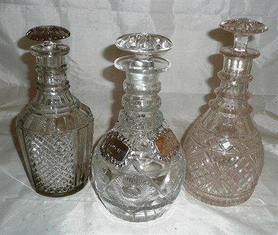 Lot 287 - A glass decanter with two silver labels