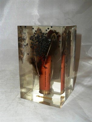 Lot 334 - A cartridge case ornament in a perspex case