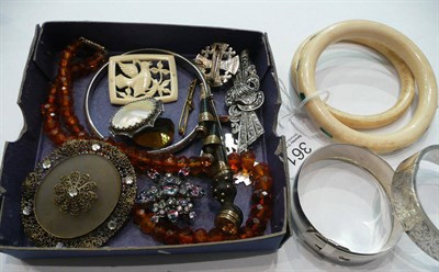 Lot 361 - Three silver bangles, a marcasite double clip brooch, a silver shield, two ivory bangles inset with