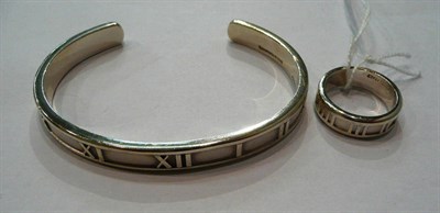 Lot 377 - A silver Roman numeral cuff bangle, by Tiffany, with matching ring